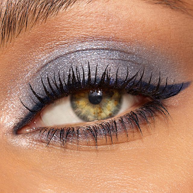 Model with green eyes wearing Denim Dimension blue eyeshadow look