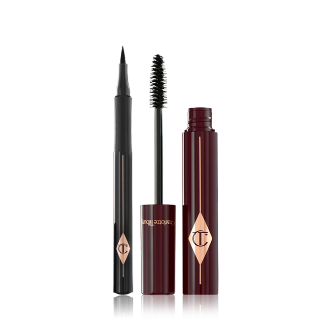 An open mascara with its applicator next to it in dark crimson-cloured packaging and an open eyeliner pen in black colour.