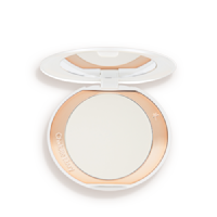 An open, setting powder compact with a mirrored-lid and white and gold-coloured packaging.
