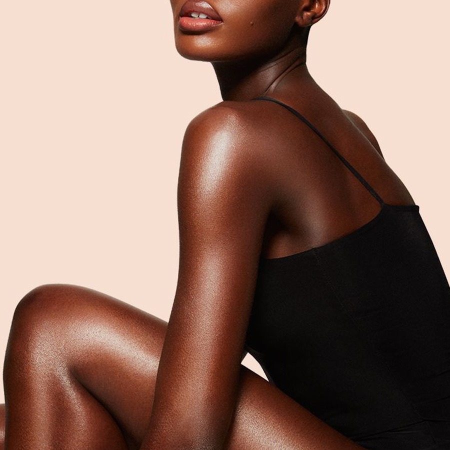 Model wearing Supermodel Body as a shimmering body highlighter