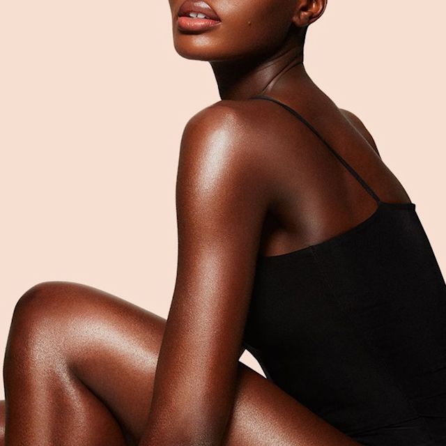 Model wearing Supermodel Body as a shimmering body highlighter