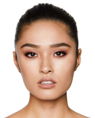 Fair-tone model with brown eyes wearing shimmery topaz and brown eye shadow with nude peach lipstick. 