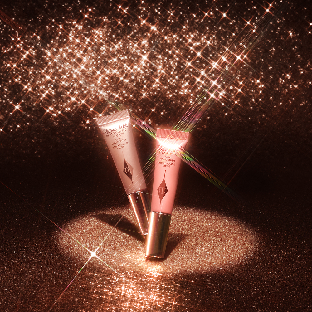 A mini liquid blush and mini liquid highlighter in pink pillow talk colours on a sparkly background