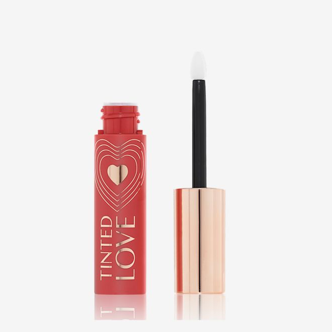 Tinted Love in Bohemian Kiss open An open lip and cheek tint with a gold-coloured lid in a warm peachy-brown-coloured tube.