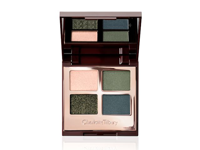 An open, mirrored-lid quad eyeshadow palette with eyeshadows in shades of shimmery dark green, teal, light green, and a light rose gold. 