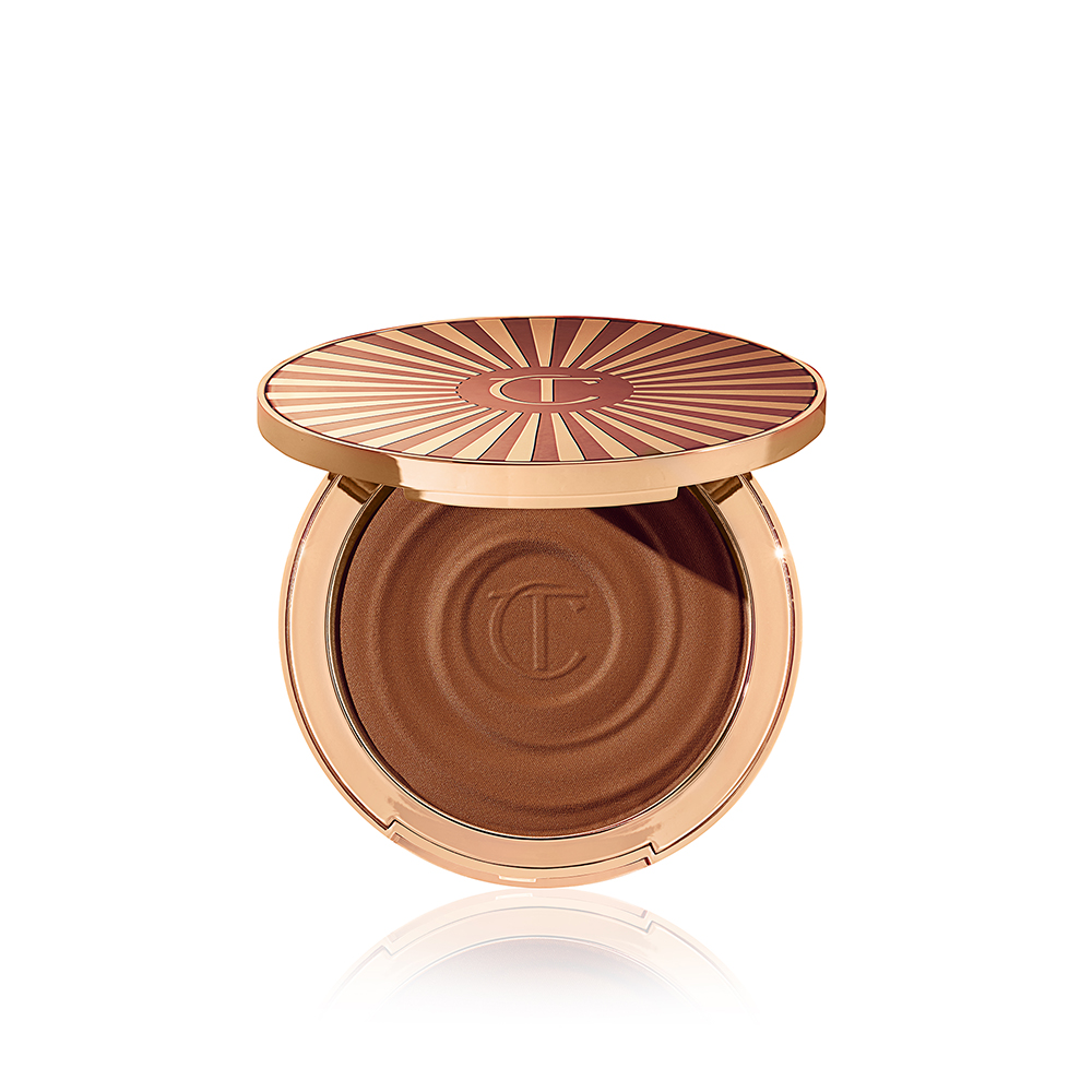 Open, cream bronzer compact in a light-sandy-brown shade with gold-coloured packaging.