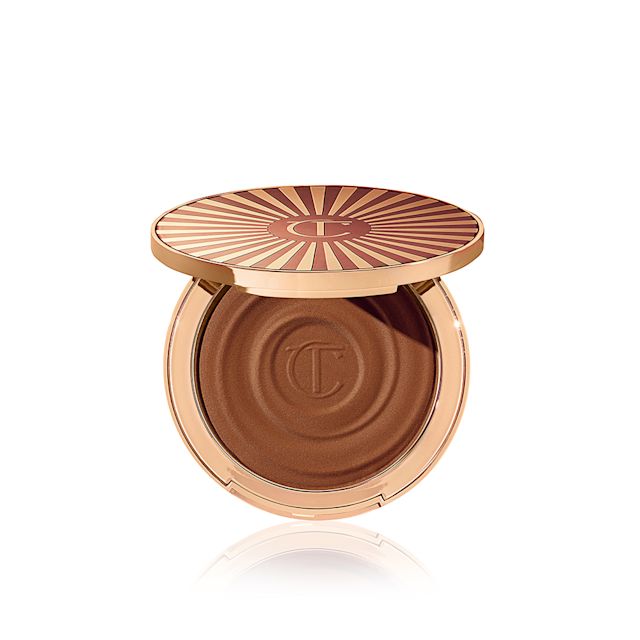 Open, cream bronzer compact in a light-sandy-brown shade with gold-coloured packaging.