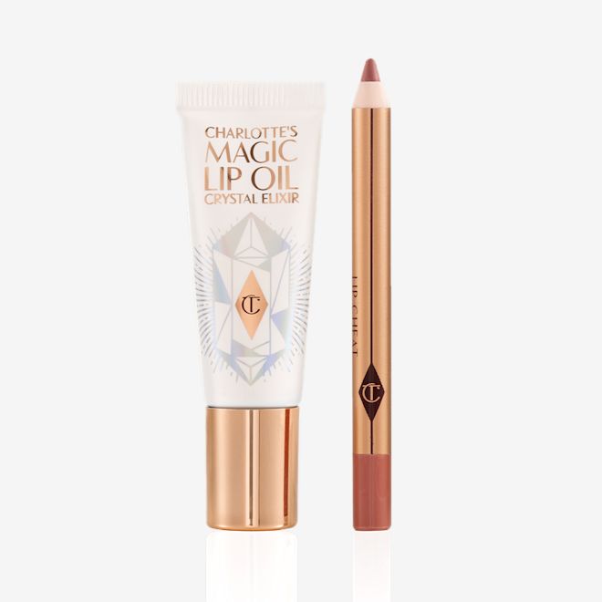 Pillow Talk Magic Kisses kit displayed Lip oil in a white-coloured tube with a gold-coloured lid along with a lip liner pencil in a nude pink shade.
