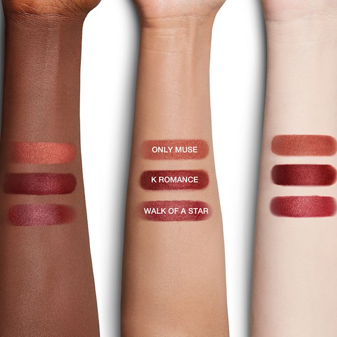 Lunar New Year Lipstick arm swatches Deep-tone, tan, and fair-tone arms with swatches of three lipsticks in a peach-terracotta, cherry red, and brownish rose.