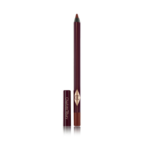 An eyeliner pencil in a berry-pink shade with its lid next to it.