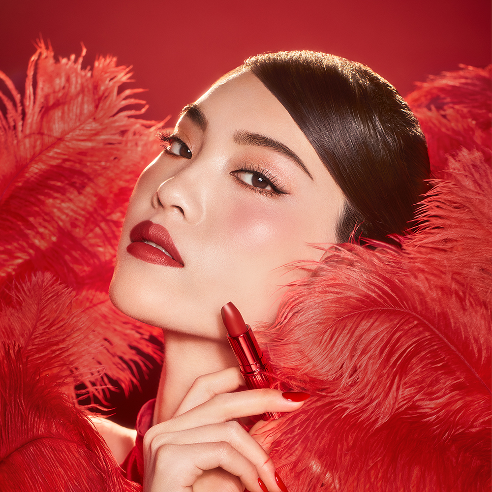 Cheng wearing Hollywood Beauty Icon Lipstick in Mark of a Kiss as a muted red bridal lipstick