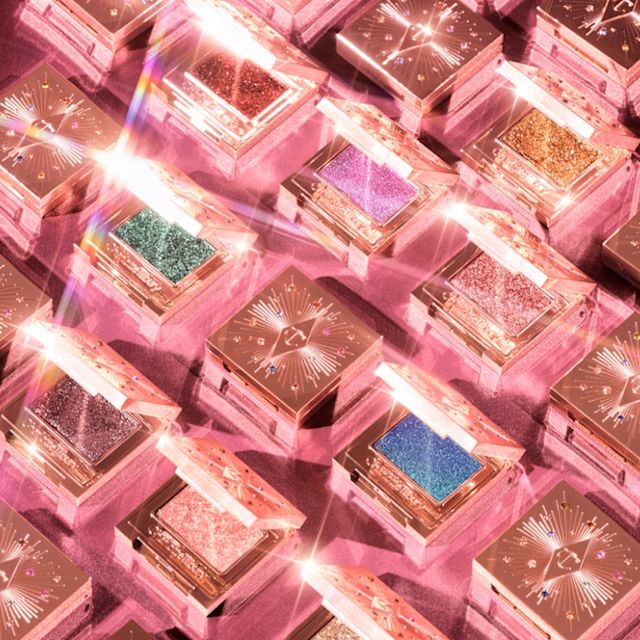 A collection of closed, single-pan, shimmery eyeshadow compacts in rose-gold packaging. 
