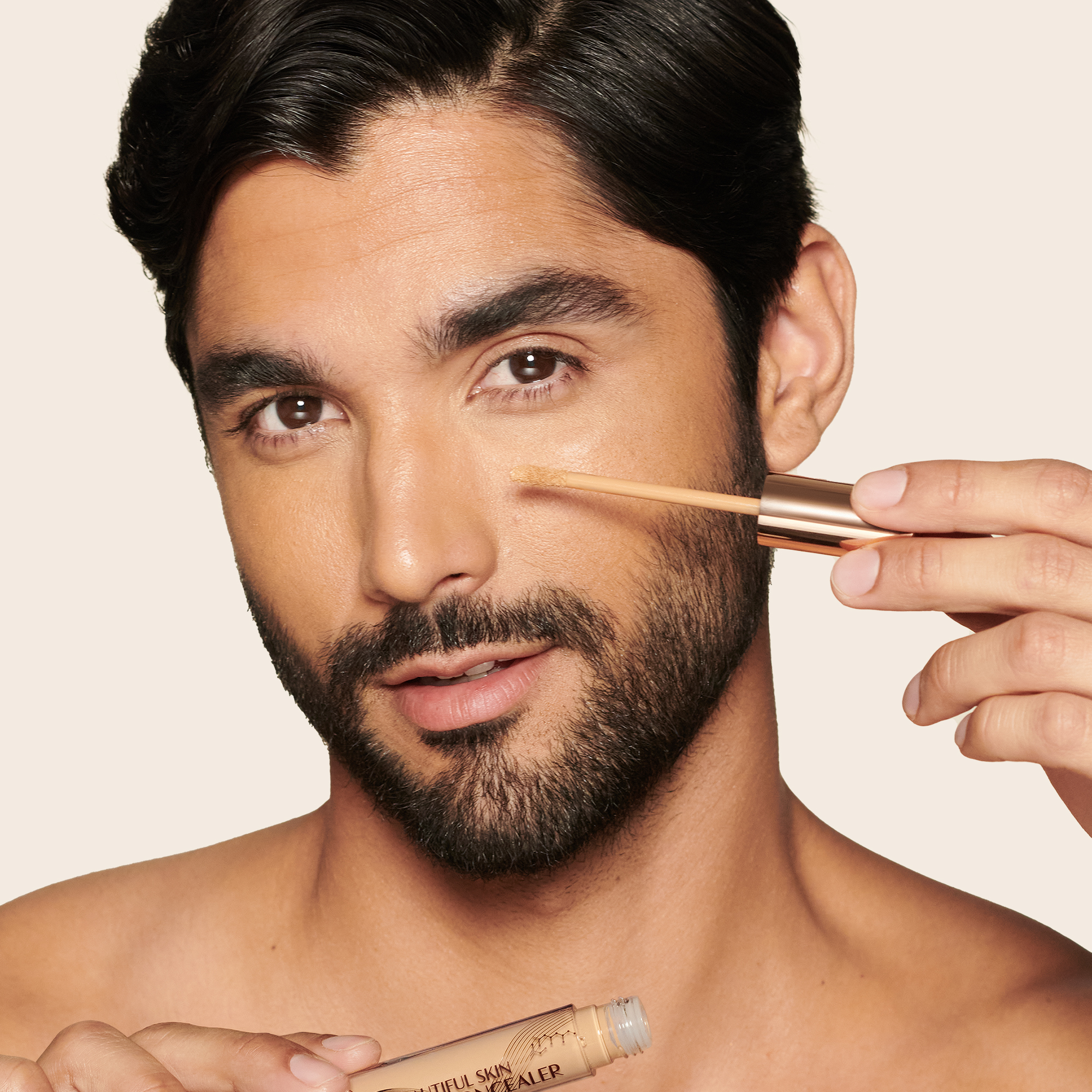 Medium-tone model with brown eyes wearing a radiant, concealer that brightens, covers blemishes, and makes her skin look fresh along with nude lip gloss and subtle eye makeup.