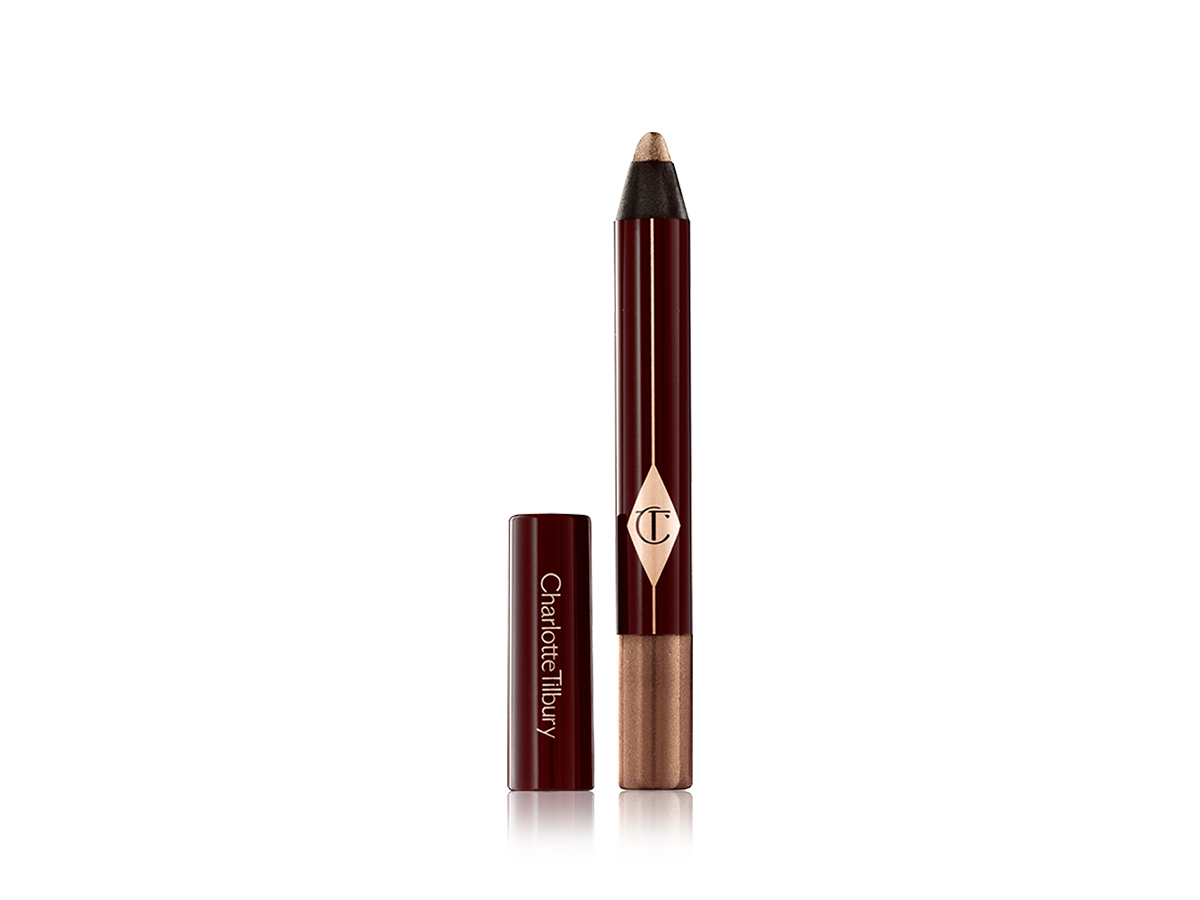 An open, chubby eyeshadow pencil in a shimmery amber shade. 