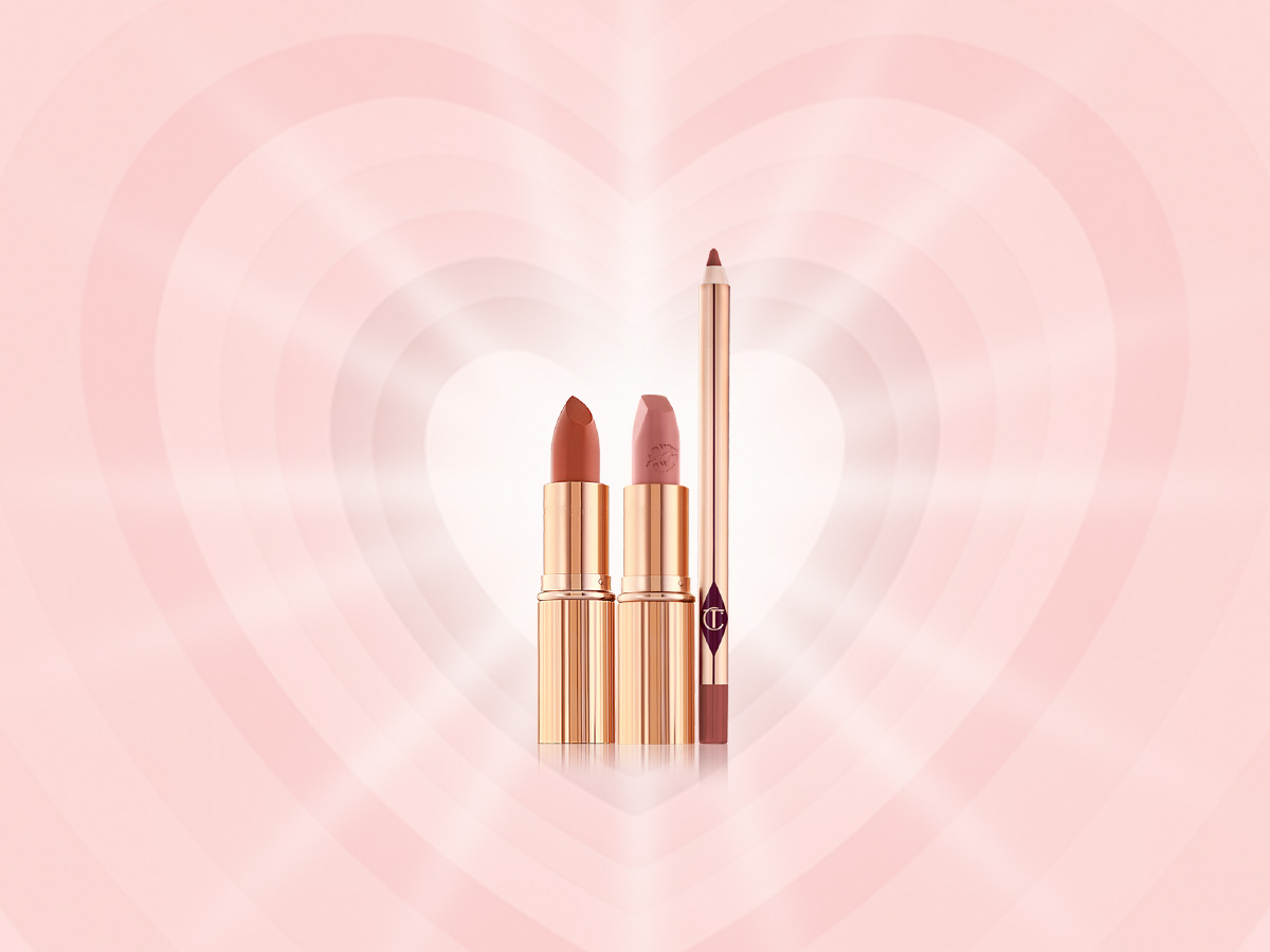 Two open lipsticks, one in a brick red shade with a satin finish and the other in a soft peachy-rose shade with a matte finish in sleek, gold-coloured tubes with a lip liner pencil in a dark brown-red shade.