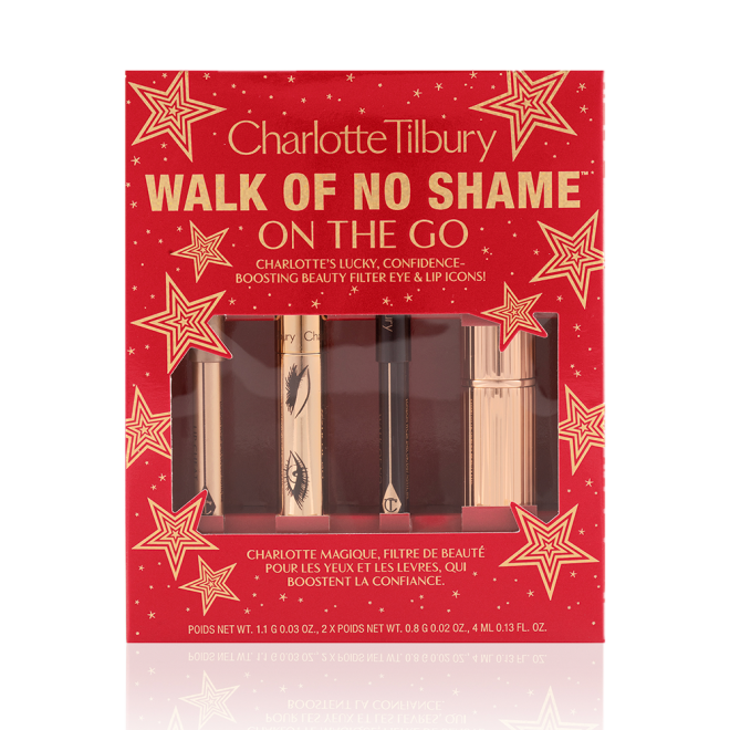 Eyeliner pencil in a berry-pink shade, mascara in a golden-coloured tube, lip liner pencil in berry-red shade, lipstick in a sleek, gold-coloured tube inside a red-coloured gift box with text on it reads, 'Walk of no shame on the go'. 