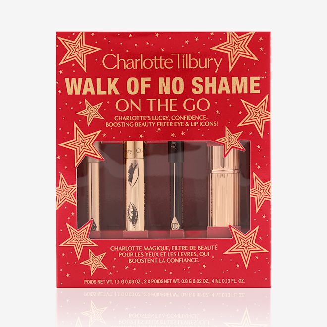 Walk of No Shame On the Go kit packed Eyeliner pencil in a berry-pink shade, mascara in a golden-coloured tube, lip liner pencil in berry-red shade, lipstick in a sleek, gold-coloured tube inside a red-coloured gift box with text on it reads, 'Walk of no shame on the go'.
