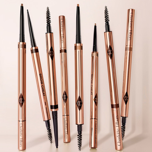 A collection of double-sided brow tint and spoolie brushes in gold-coloured packaging.