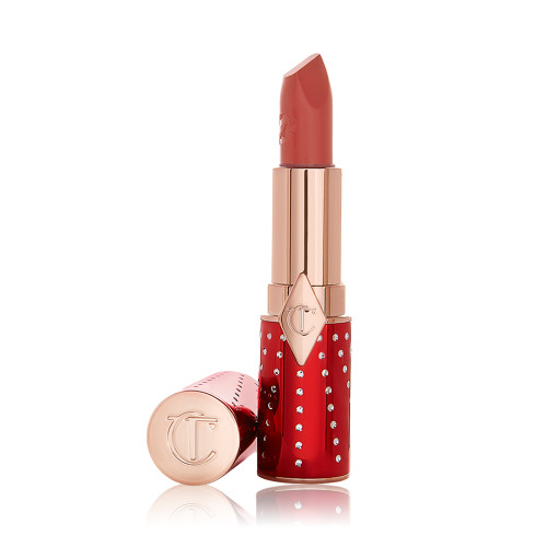 An open lipstick in a rusty rose-coloured shade with a satin-finish in a red and gold-coloured tube.