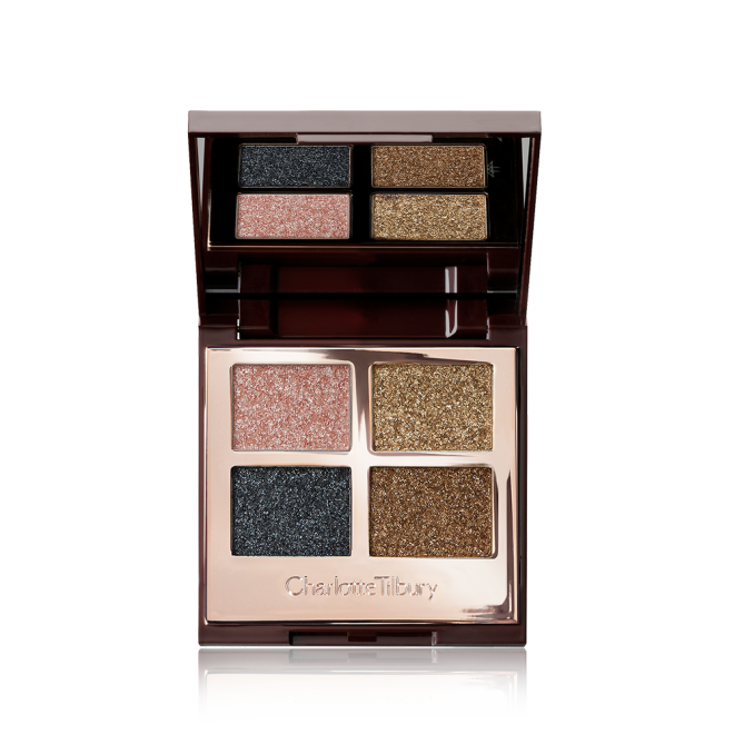 An open, mirrored-lid quad eyeshadow palette with shimmery eyeshadows in rose gold, teal, honey-gold, and bright gold colours. 