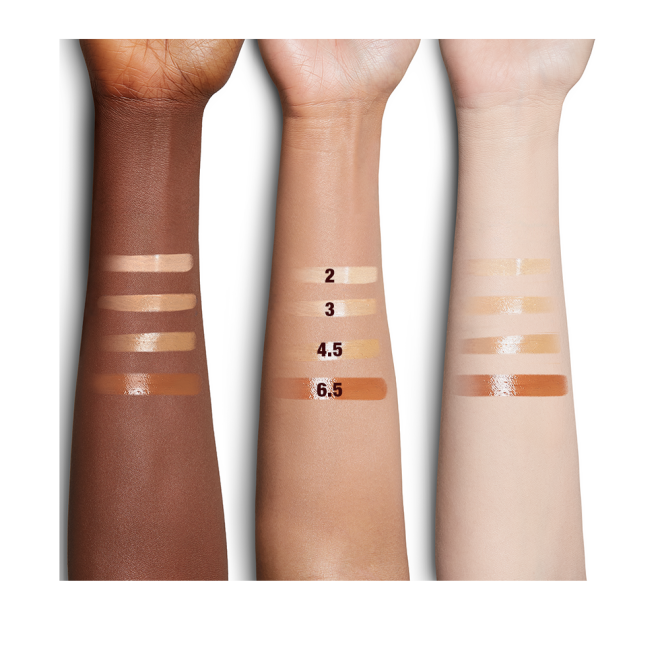 Fair, medium, and deep-tone arm swatches of four glow-boosting primer in light, medium-light, medium-dark, and deep shades. 