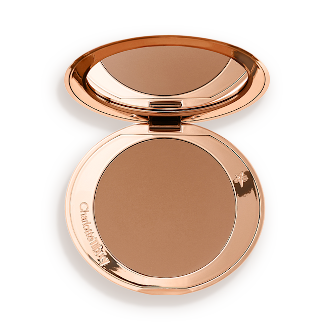 Airbrush Bronzer in Medium open An open mirrored-lid bronzer compact in a medium-brown shade.