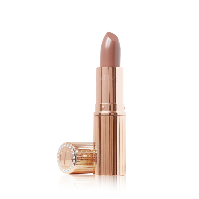 An open lipstick in a cool nude-beige shade with a satin-finish and its lid next to it. 
