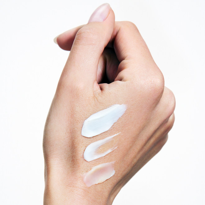 Three Magic Water Cream swatches on hand with a white background