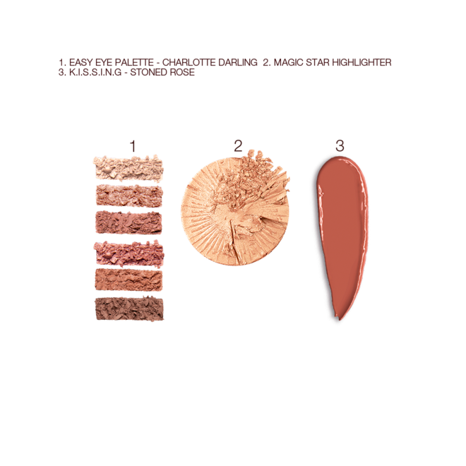 Charlotte's Mesmerising Glow Kit swatches Swatches of six matte and shimmery eyeshadows in shades of pink, pink, and brown, lipstick in a nude brick rose shade, and a highlighter compact in a soft gold shade.