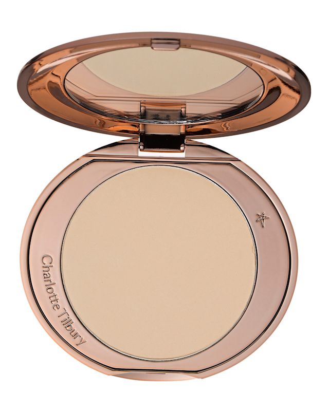 An open, mirrored-lid pressed powder compact for fair skin tones in rose-gold packaging. 