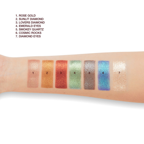 Light-tone arm with swatches of seven metallic eyeshadows in rose gold, bronze-orange, vibrant red, mint green, lilac-grey, sapphire blue, and opal.