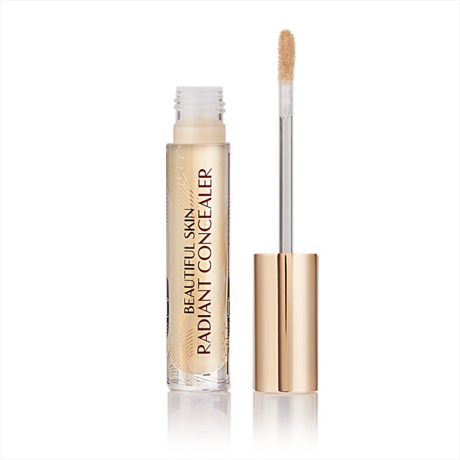 Radiant concealer in a glass tube with its doe-foot applicator next to it with a gold-coloured handle.