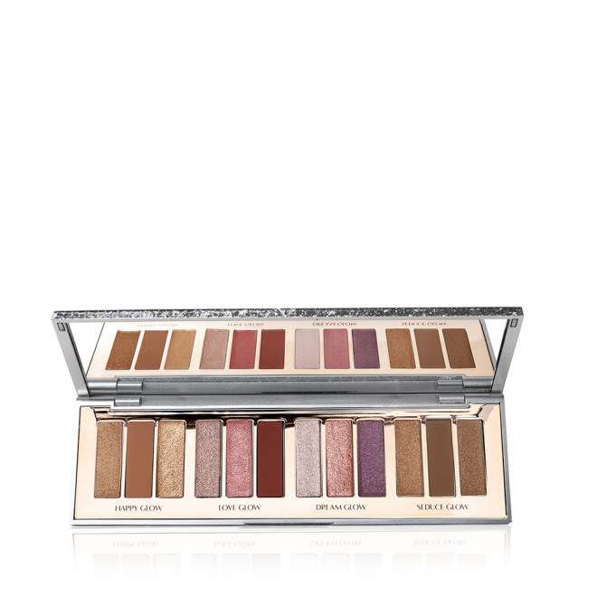 An open, mirrored-lid eyeshadow palette with twelve metallic and shimmery eyeshadows in topaz, red, purple, chocolate brown, pink and golden shades. 