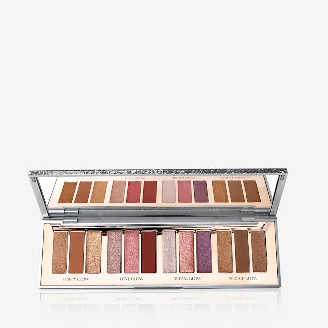 Instant Eye Palette in Bejewelled Eyes to Hypnotise open An open, mirrored-lid eyeshadow palette with twelve metallic and shimmery eyeshadows in topaz, red, purple, chocolate brown, pink and golden shades.