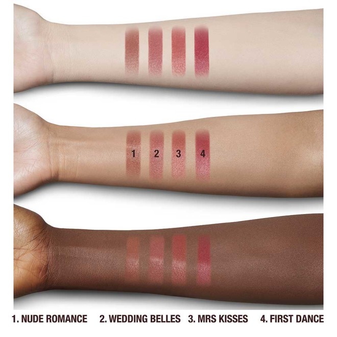 swatches of four lipsticks in shades of nude brown, nude pink, nude coral, and berry-pink on fair, tan, and deep-tone arms.