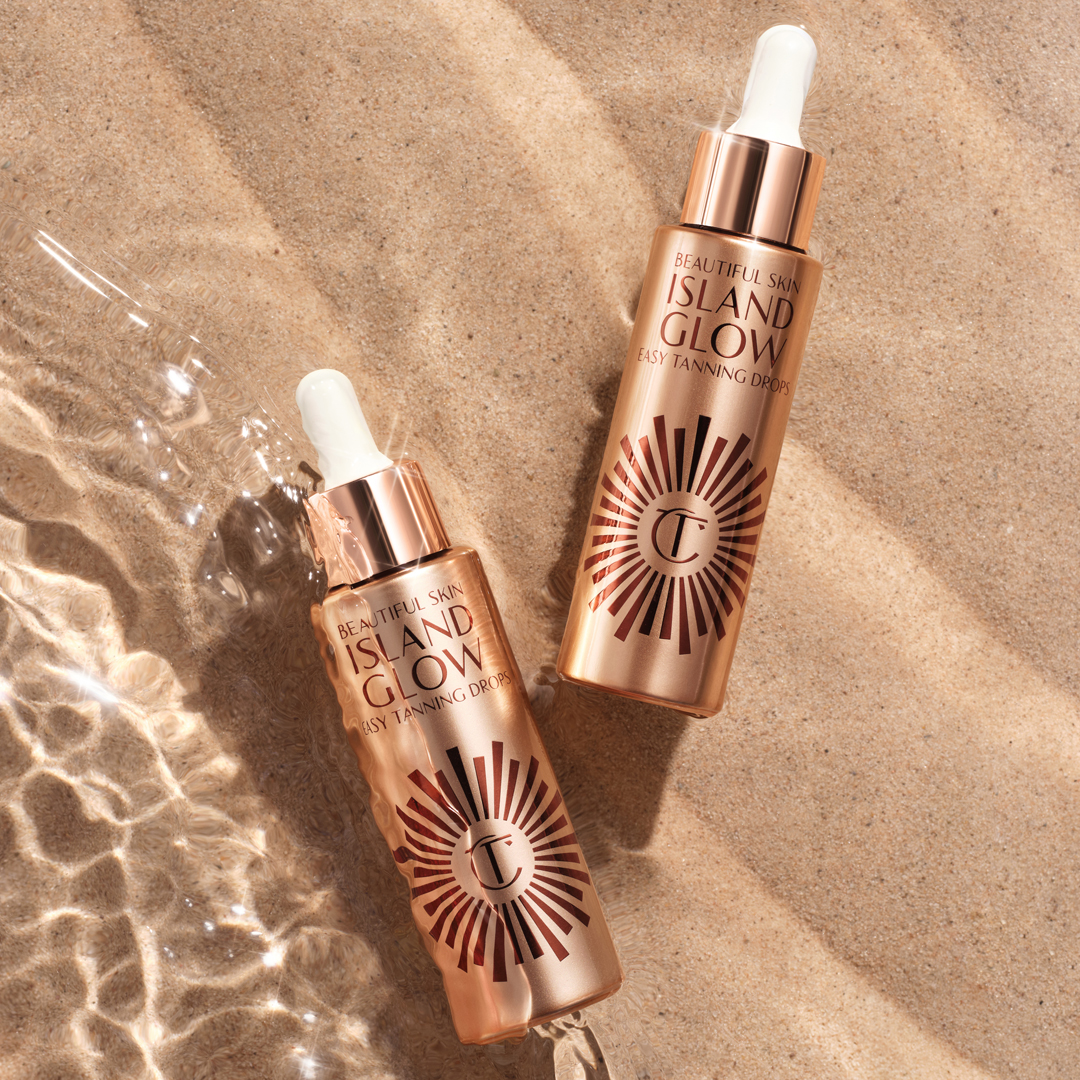 Both shades of Beautiful Skin Island Glow Easy Tanning Drops placed in sand