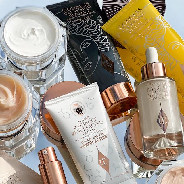 A collection of skincare items that include face creams in glass jars, facial cleansers, facial serums in glass jars, and face creams in bottles with pump dispensers.