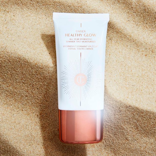 Unisex Healthy Glow tinted moisturiser with sand backdrop