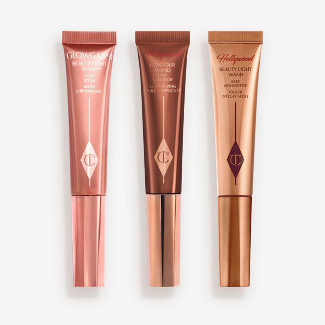 Beauty Light Wands closed Medium-pink liquid blush wand, glowy brown contour wand, and soft candlelight-gold-coloured liquid highlighter wand.