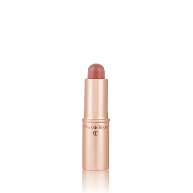 An open, lip and cheek colour stick in a glowy soft pink shade in a golden-coloured tube.