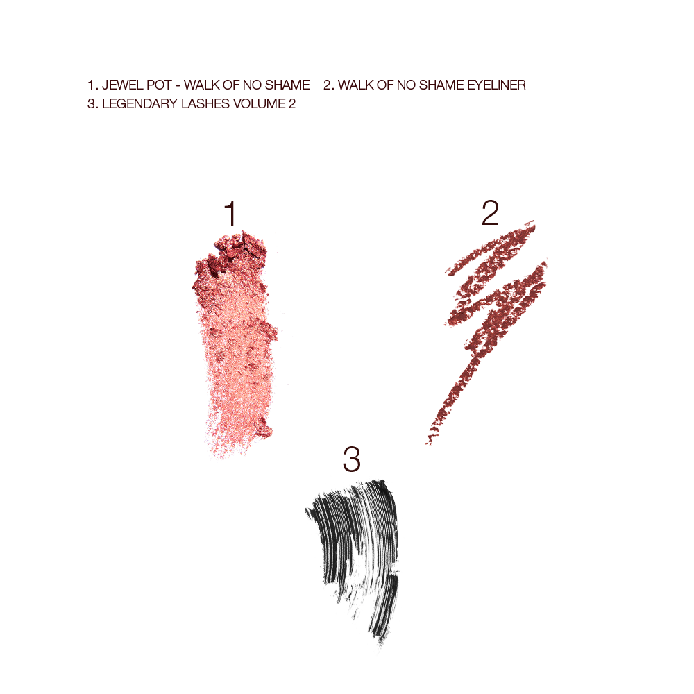 Swatches of a cream eyeshadow in a rose gold shade, eyeliner in a berry-pink, and black mascara.