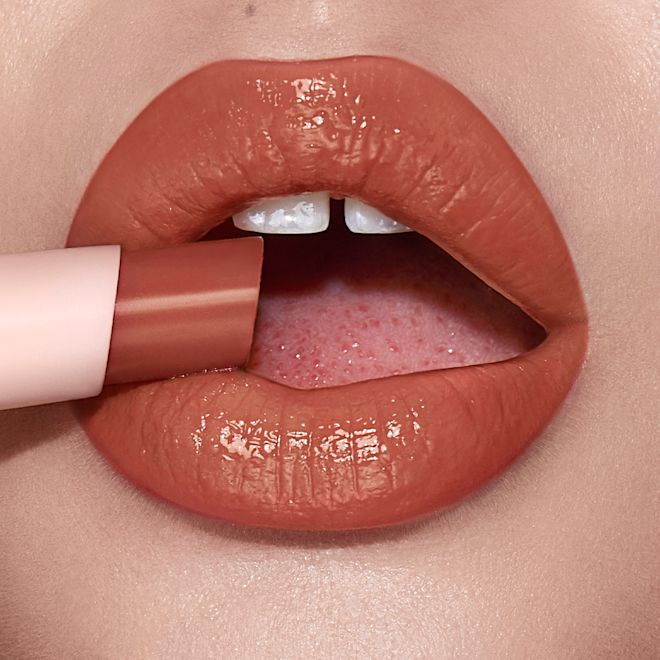 hyaluronic Happikiss in Happipeach on light-tone model Lips close-up of a light-tone model wearing a moisturising lipstick balm in a peachy-nude shade.