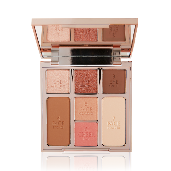 An open, mirrored-lid face palette with nude eyeshadows, nude pink and soft pink blushes, bronzer, and highlighter. 