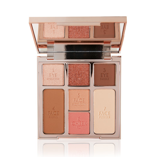 An open, mirrored-lid face palette with nude eyeshadows, nude pink and soft pink blushes, bronzer, and highlighter. 