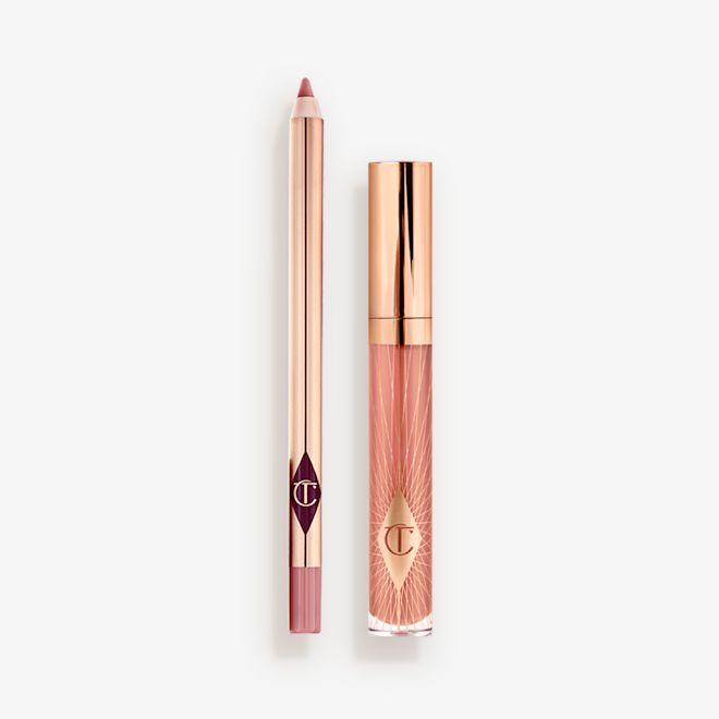 Pillow Talk Kisses lip gloss and lip liner pencil bundle A closed, nude-pink lip gloss with a rose gold lid with an open, nude-pink lip liner pencil with a rose gold body.