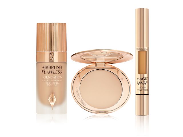 Foundation in frosted glass bottle with gold lid, pressed powder compact with mirrored-lid, and liquid concealer in gold-coloured tube. 