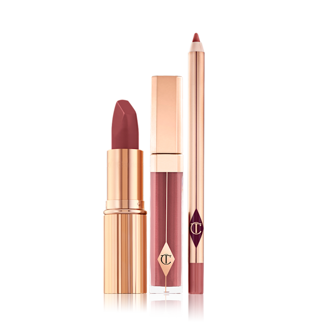Luscious Lip Slick displayed An open matte lipstick with a high-shine lip gloss in a glass tube with a gold-coloured lid, and open lip liner pencil with a matte finish.