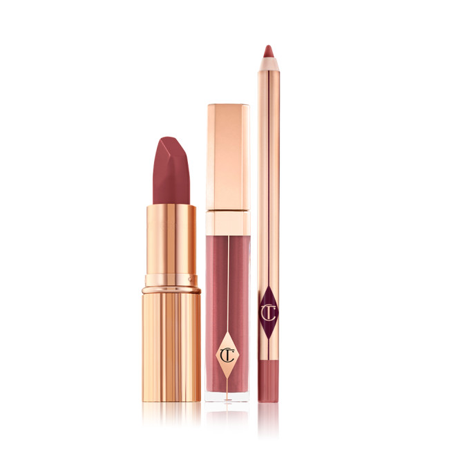 An open matte lipstick with a high-shine lip gloss in a glass tube with a gold-coloured lid, and open lip liner pencil with a matte finish.