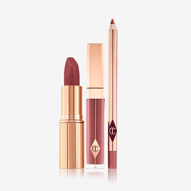 Luscious Lip Slick displayed An open matte lipstick with a high-shine lip gloss in a glass tube with a gold-coloured lid, and open lip liner pencil with a matte finish.