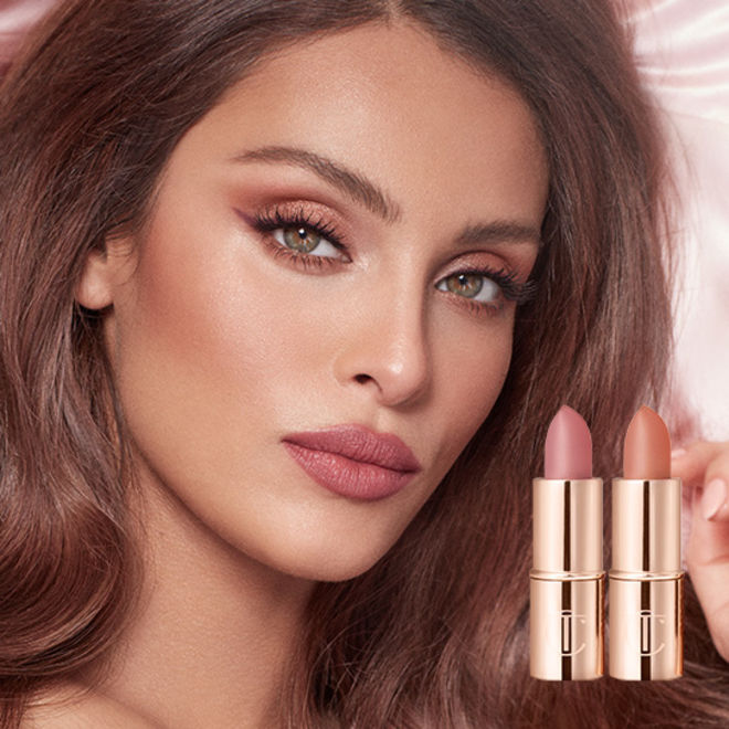 Magic Cream Light Cat Box Lips close-up of a fair-tone model applying a high-shine lip gloss in a pinkish peach shade.